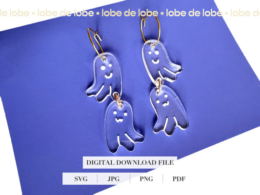 Transparent ghost-shaped earrings on a blue background with 'lobe de lobe' branding.